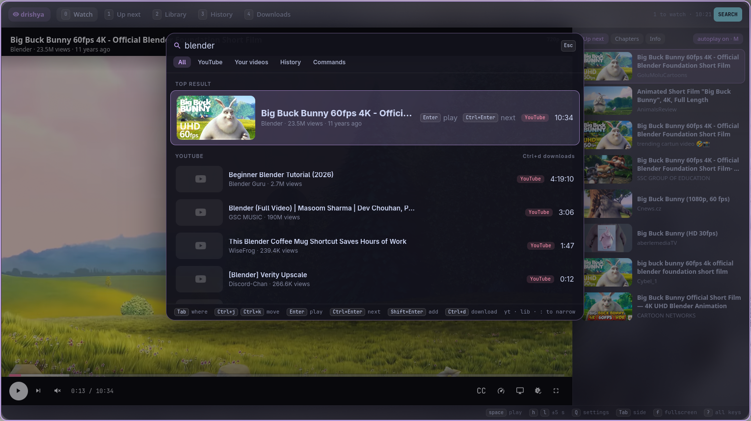 The search panel: the top result from YouTube with its thumbnail, more results, and the keys